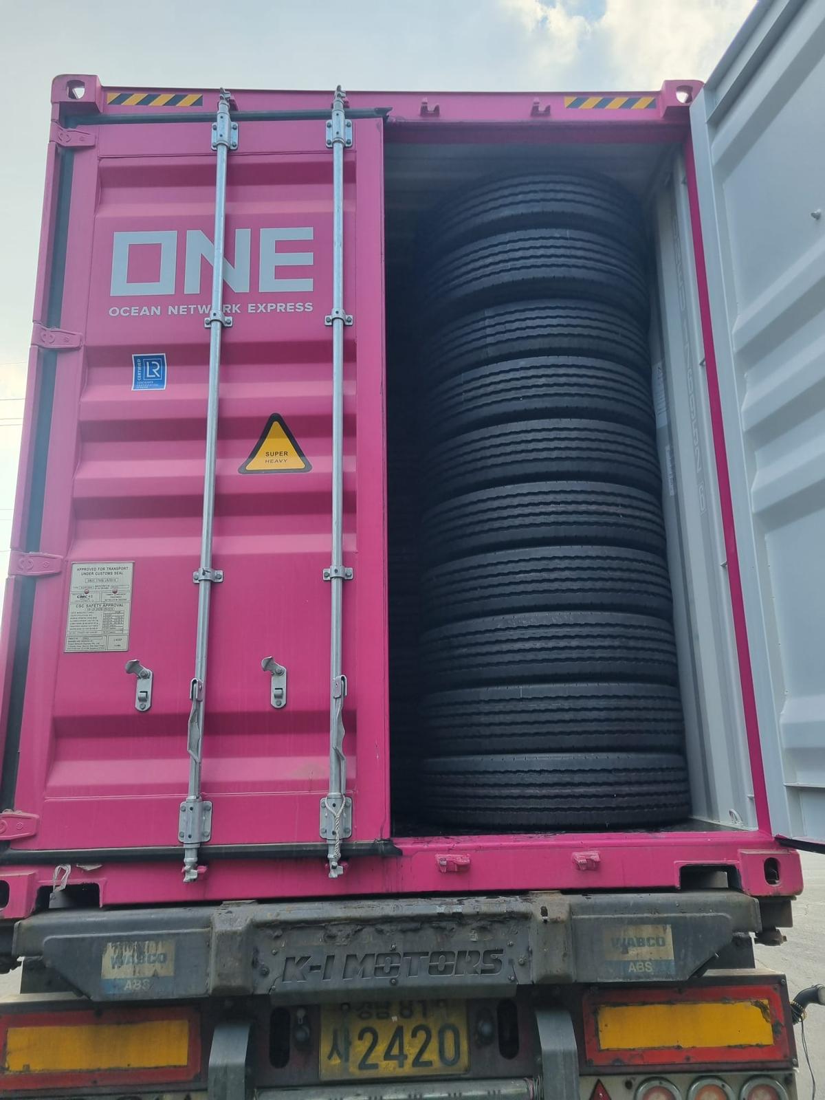 Truck tyres stacked high inside a container